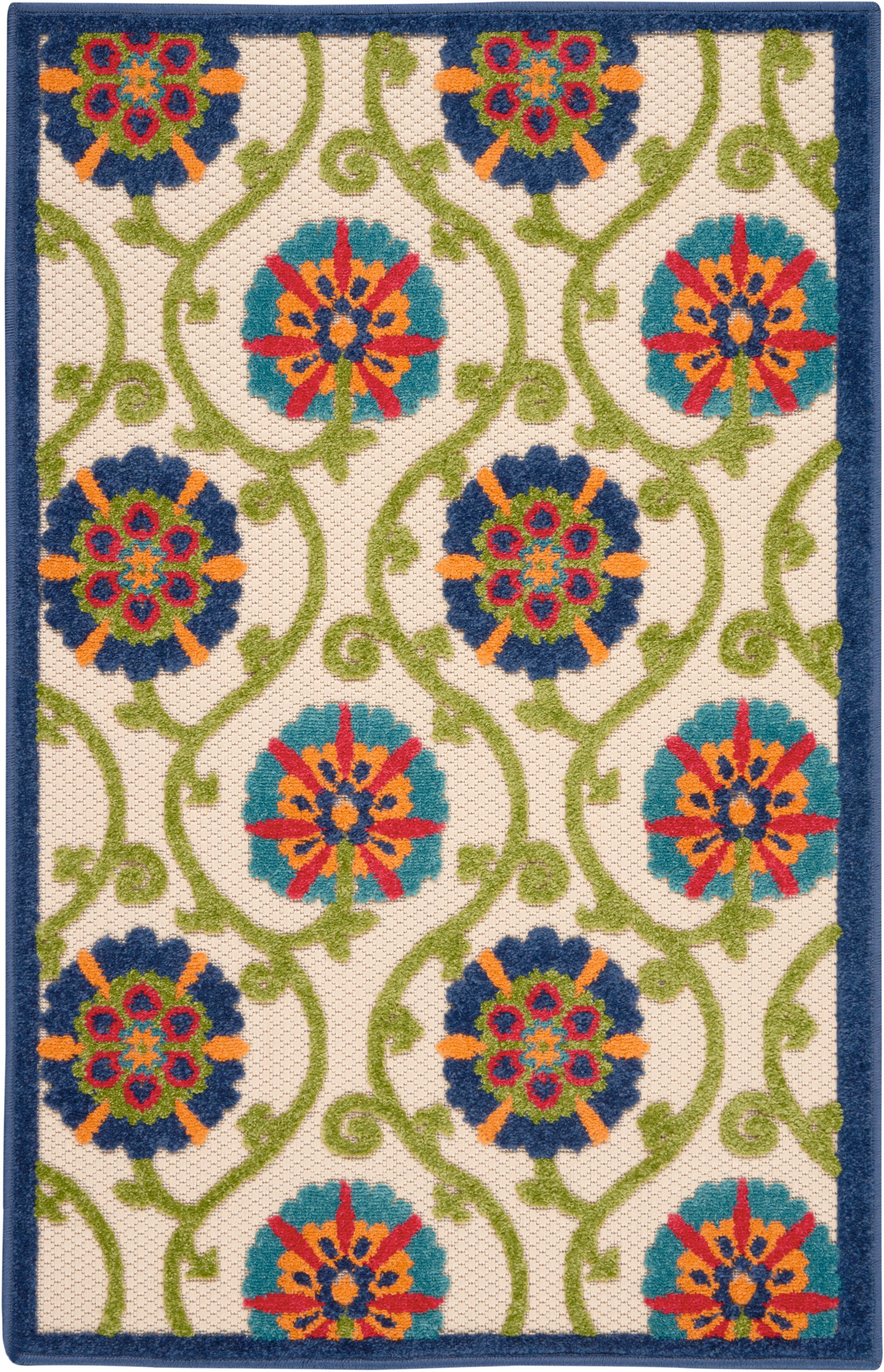 Rectangular woven rug with cream background, teal and blue floral medallions connected by lime green vines, navy border.
