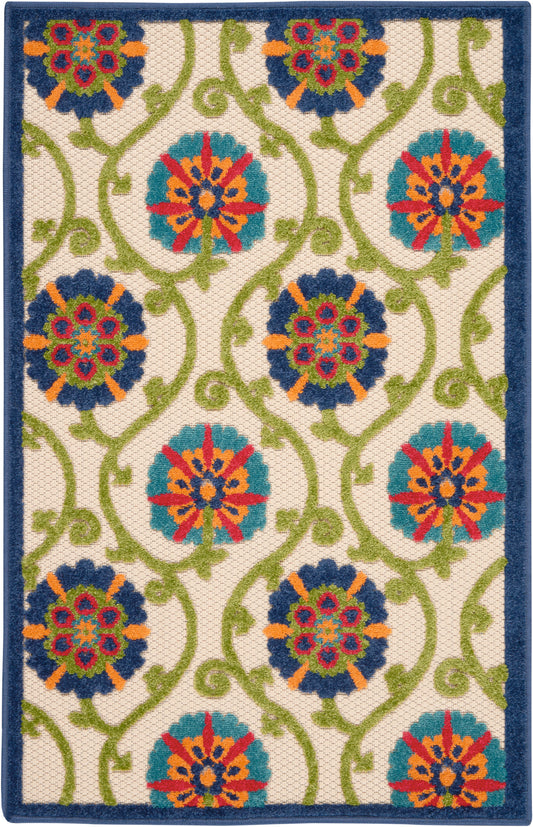 Rectangular woven rug with cream background, teal and blue floral medallions connected by lime green vines, navy border.