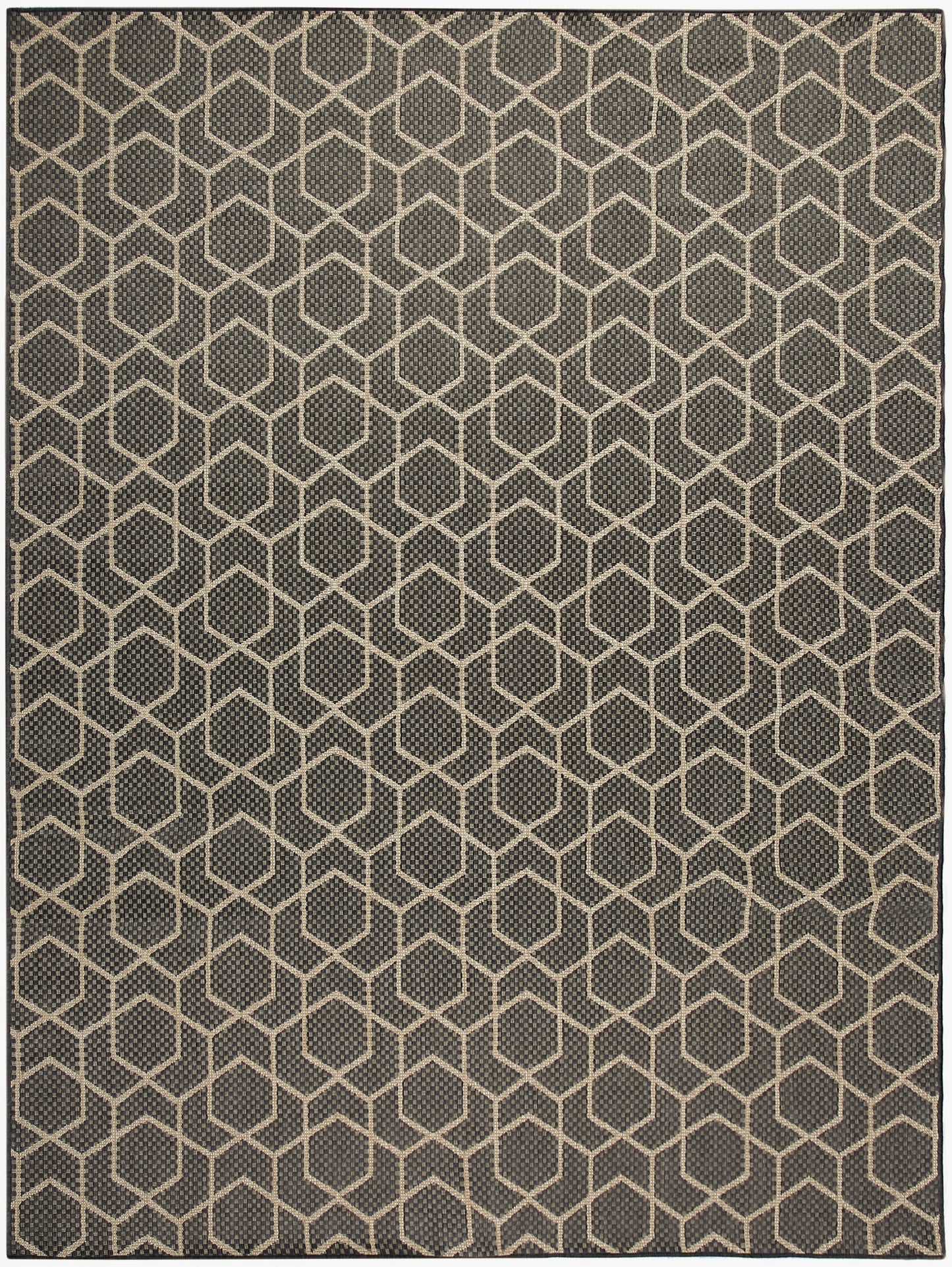 Dark gray area rug with beige hexagon honeycomb pattern; geometric, textured weave.