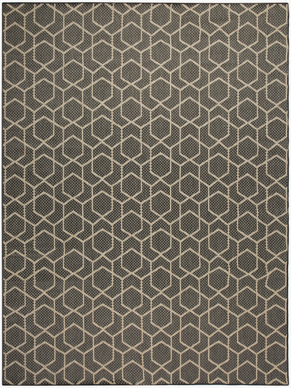 Dark gray area rug with beige hexagon honeycomb pattern; geometric, textured weave.