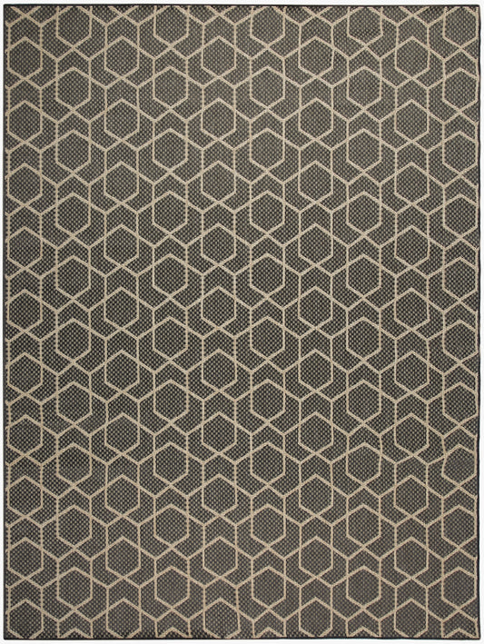 Dark gray area rug with beige hexagon honeycomb pattern; geometric, textured weave.