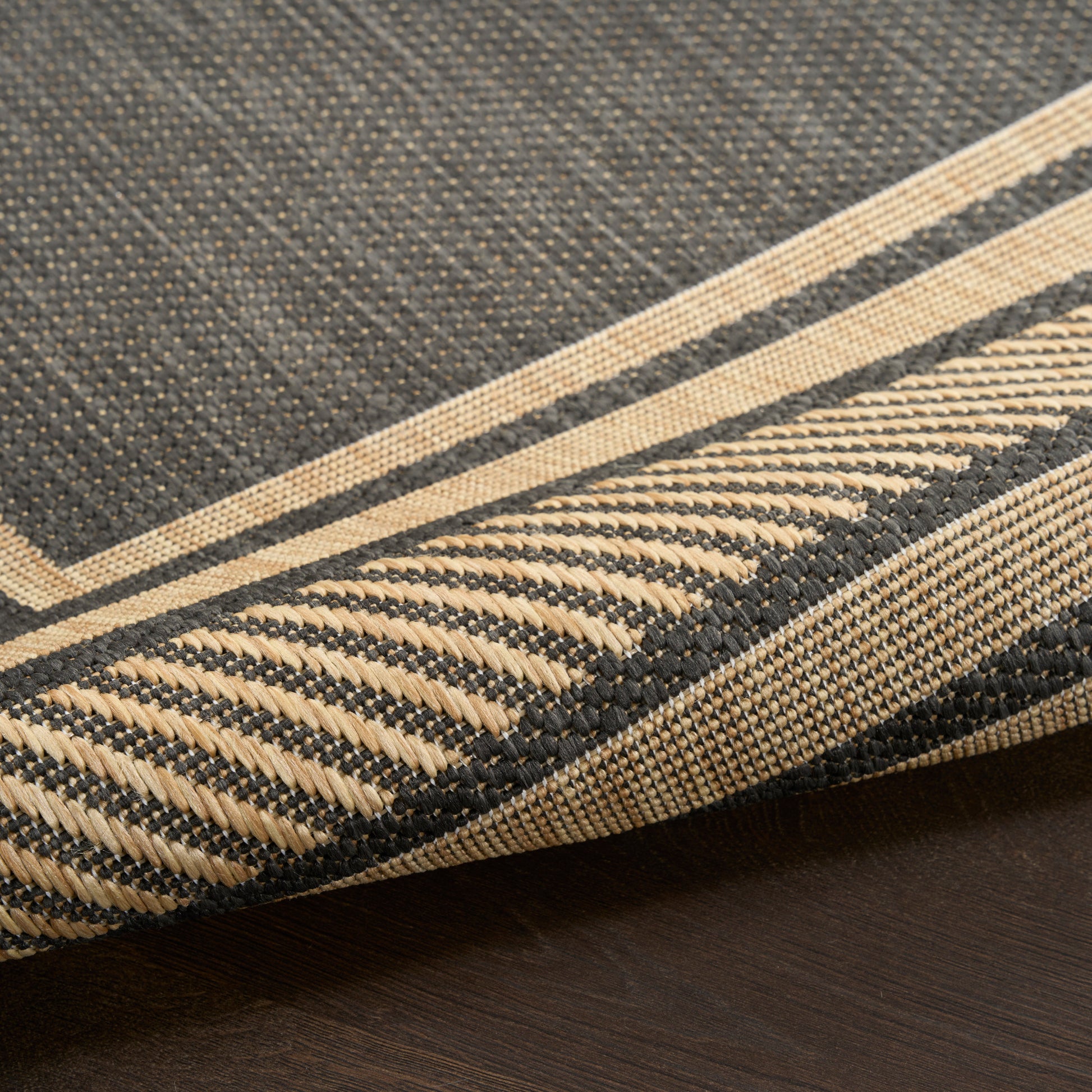 Close-up of a navy blue & natural beige striped woven runner rug with fringe, textured cotton weave.
