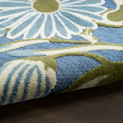 Close-up of blue outdoor rug featuring white and light-blue floral pattern with olive-green vines.