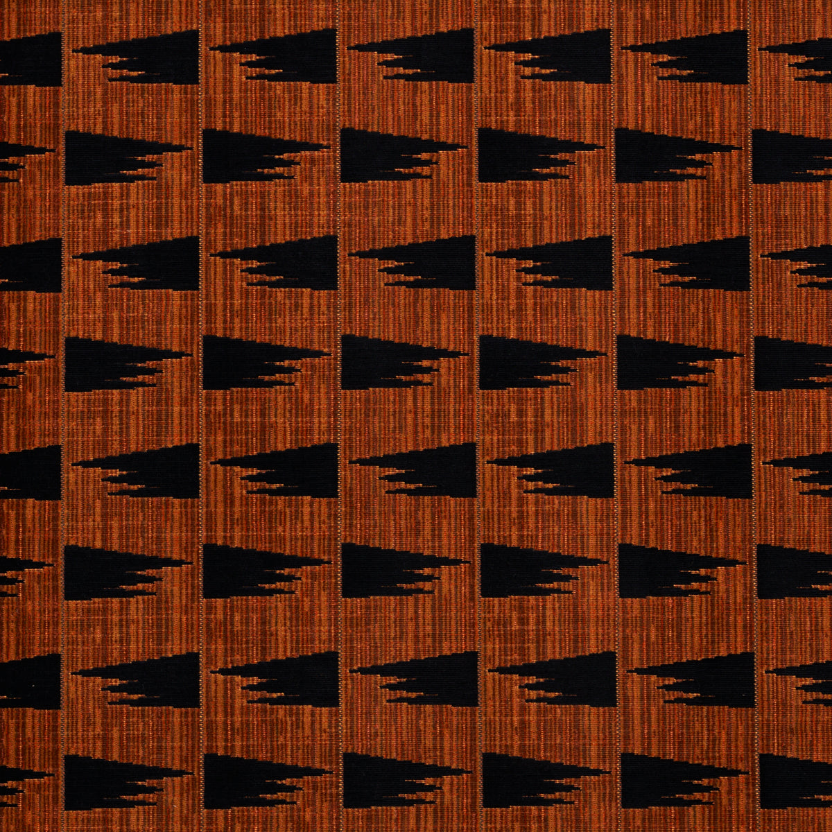 Repeating black arrowhead shapes on a burnt orange wood-textured background; bold geometric fabric pattern.