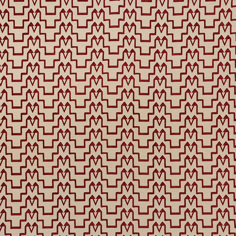 Beige chenille fabric with repeating red interlocking chevrons; bold geometric upholstery textile.