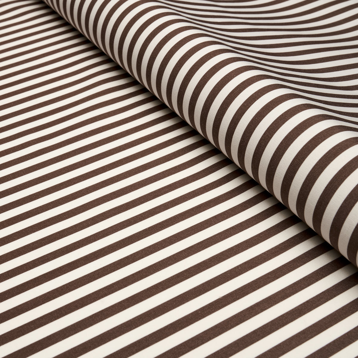 Brown and white striped fabric roll with curved folds; soft textile suitable for clothing or upholstery.