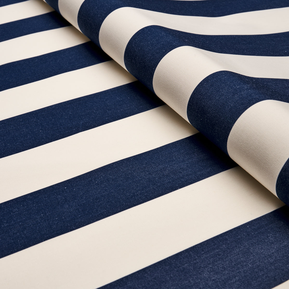 Navy blue and white striped fabric, partially rolled, cotton-like material with bold nautical stripes.