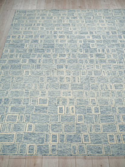 Blue rug with cream rectangular grid pattern; modern, soft-textured.