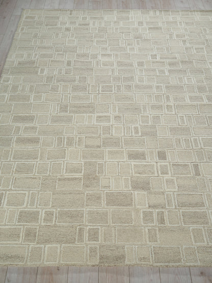 Beige area rug with cream geometric grid of squares and rectangles, soft textured look, modern living room decor.