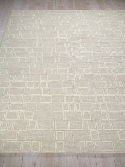 Cream rectangular rug with a modern geometric grid of square outlines in pale cream tones.