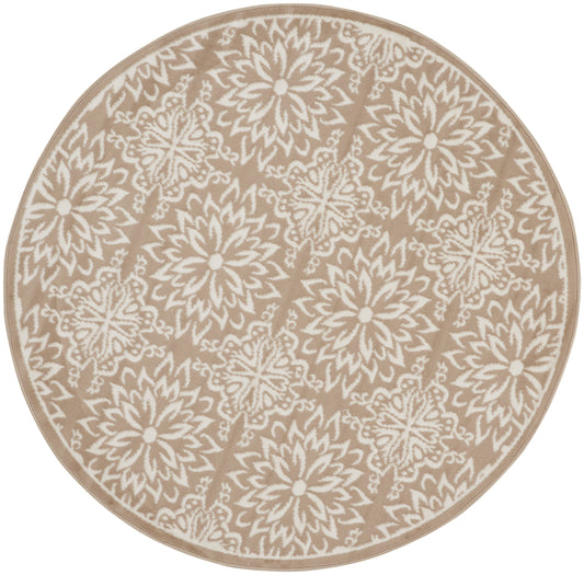 Round beige rug with white floral mandala motifs and beige border.