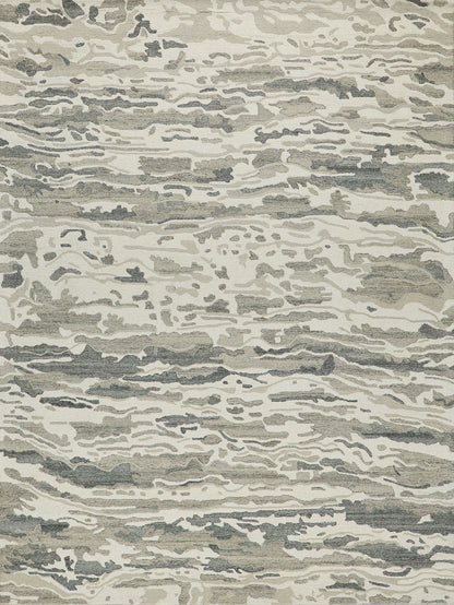 Modern abstract area rug in beige, gray and taupe with irregular, flowing wave patterns.