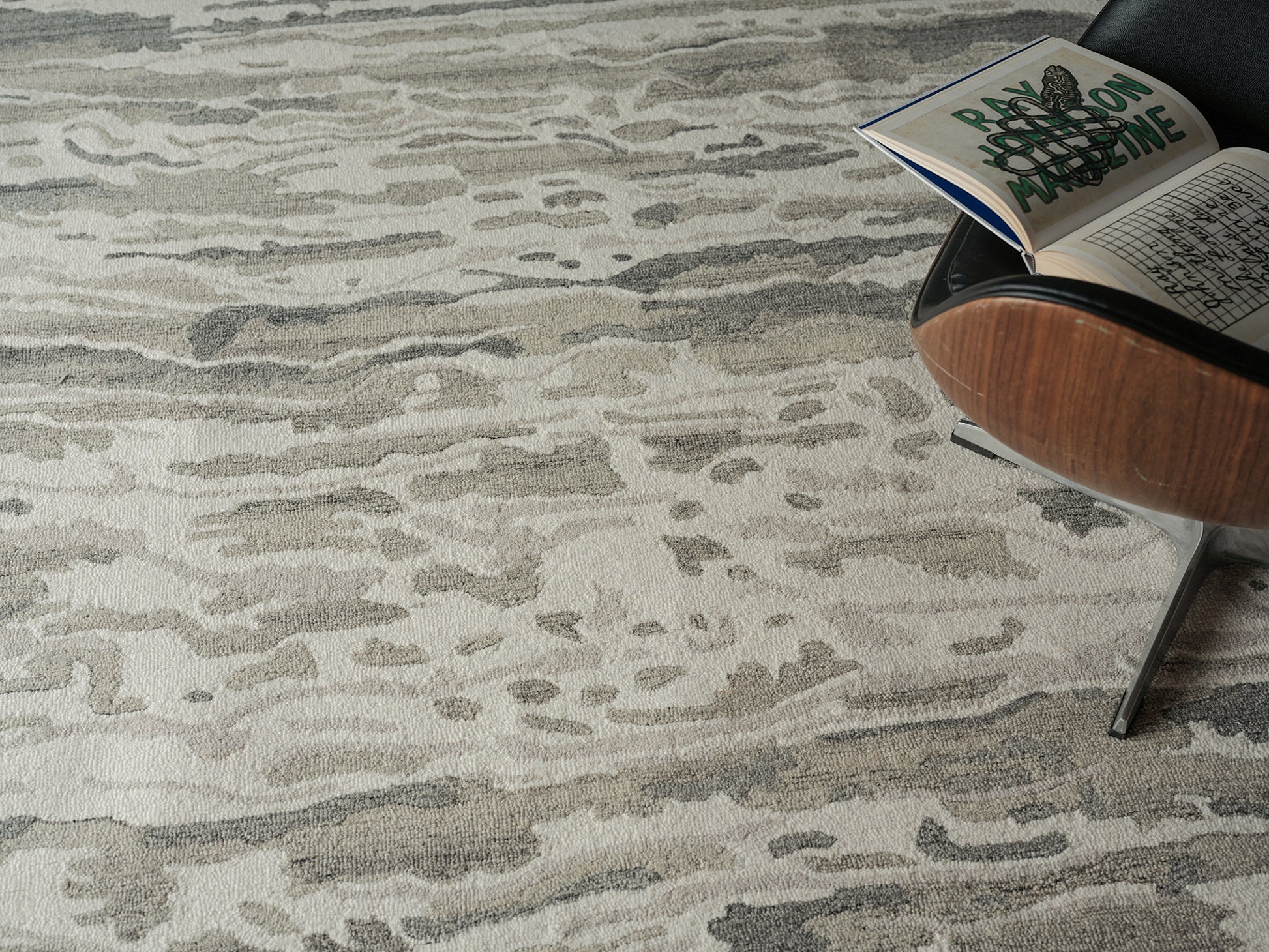 Neutral beige-gray abstract patterned area rug with soft pile, modern home decor.