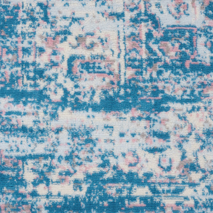 Blue, pink and ivory abstract patterned rug with a distressed vintage look.