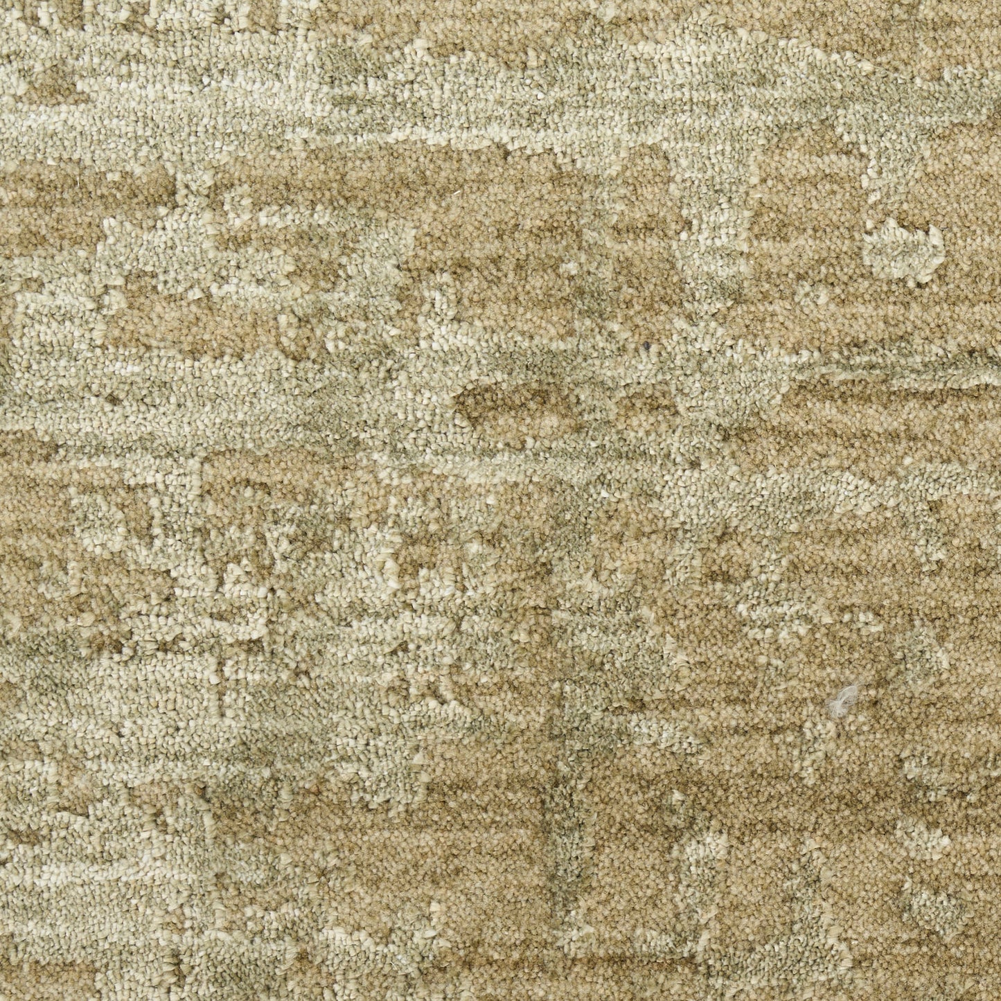 Beige-tan textured rug close-up with a subtle abstract pattern and soft plush pile.