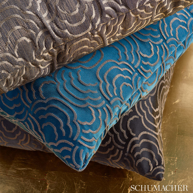 Stacked decorative pillows in blue, gray & brown velvet with metallic silver cloud-like embroidery.
