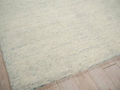 Beige & pale blue woven rug with subtle stripes on light wood floor.