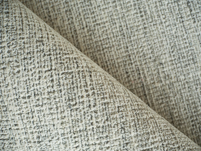 Beige textured woven rug with a subtle grid pattern, folded to reveal a soft, plush pile.