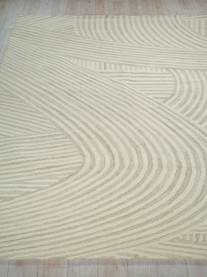 Beige area rug with cream curved line pattern; soft pile and modern geometric design for living areas.