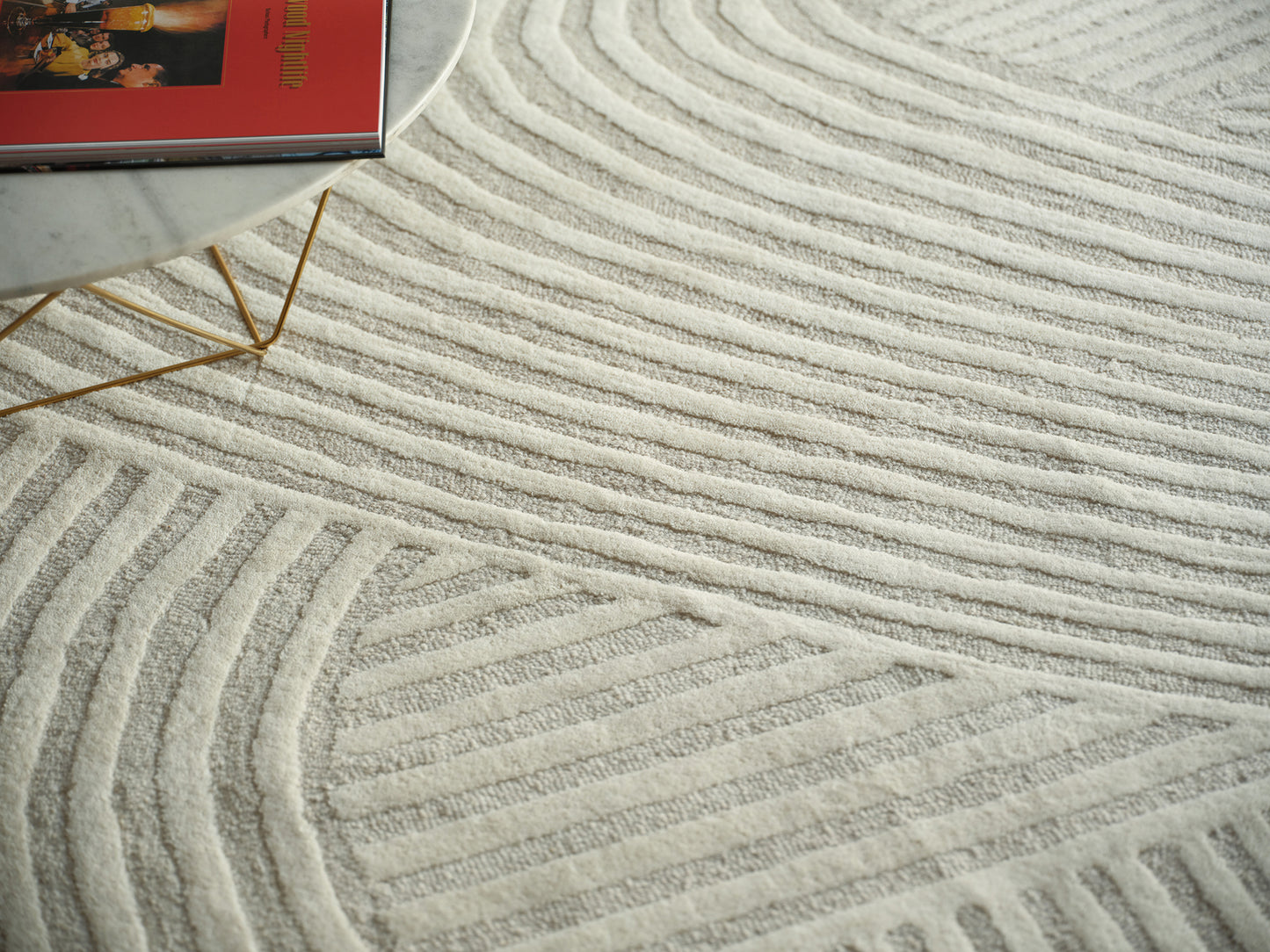 Cream textured area rug with raised wavy stripes.