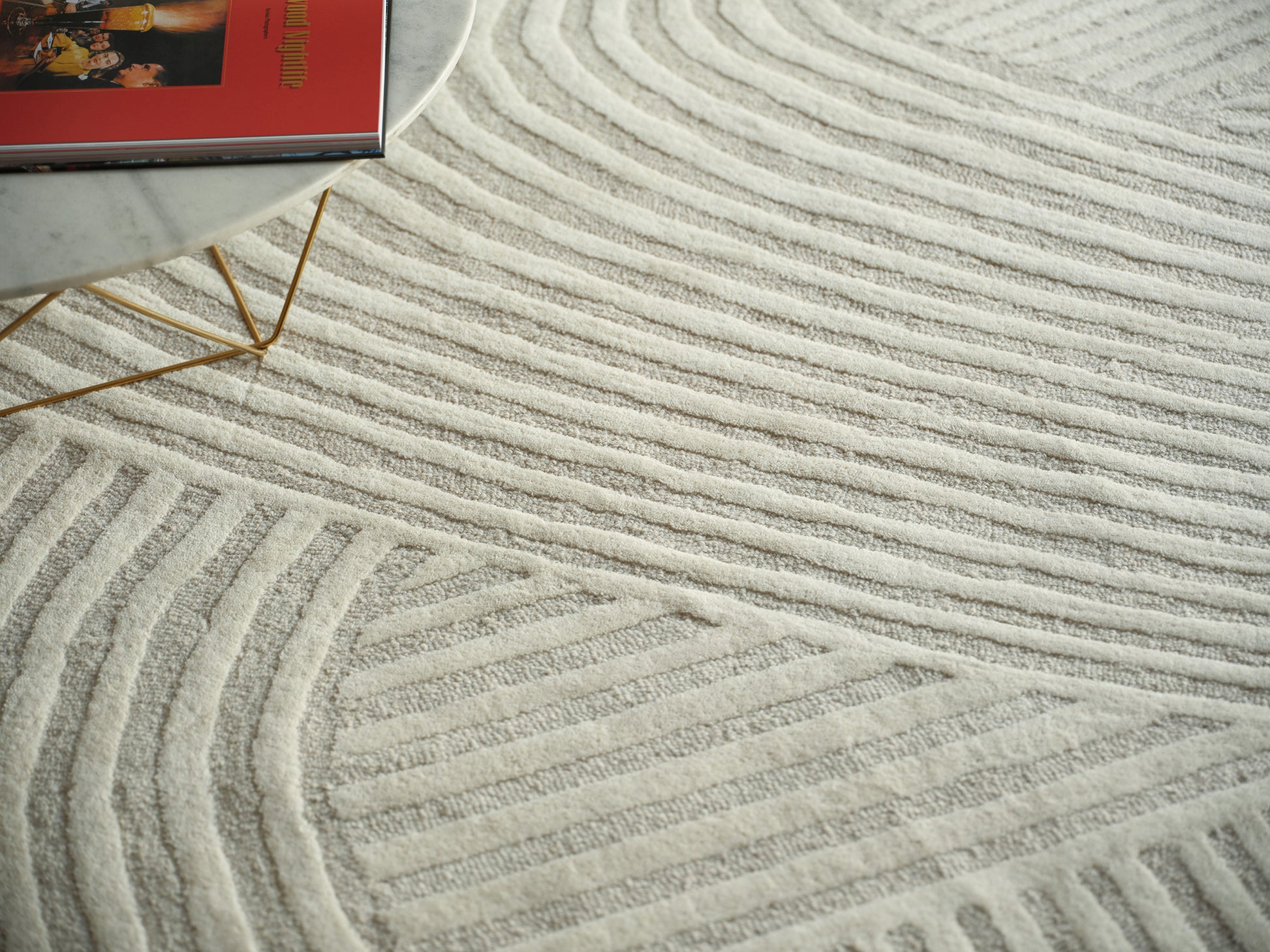 Cream textured area rug with raised wavy stripes.