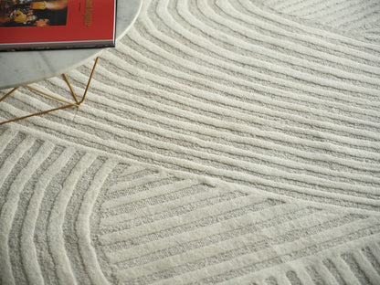 Cream textured area rug with raised wavy stripes.