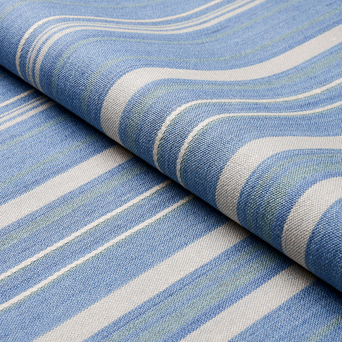 Blue striped chambray woven fabric with white and pale stripes; soft drape, ideal for throws or cushions.