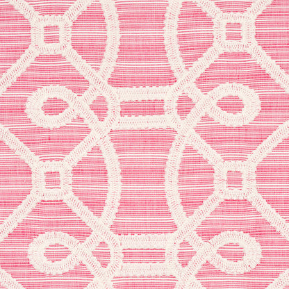 Pink fabric with white embroidered geometric lattice pattern of loops and square shapes.