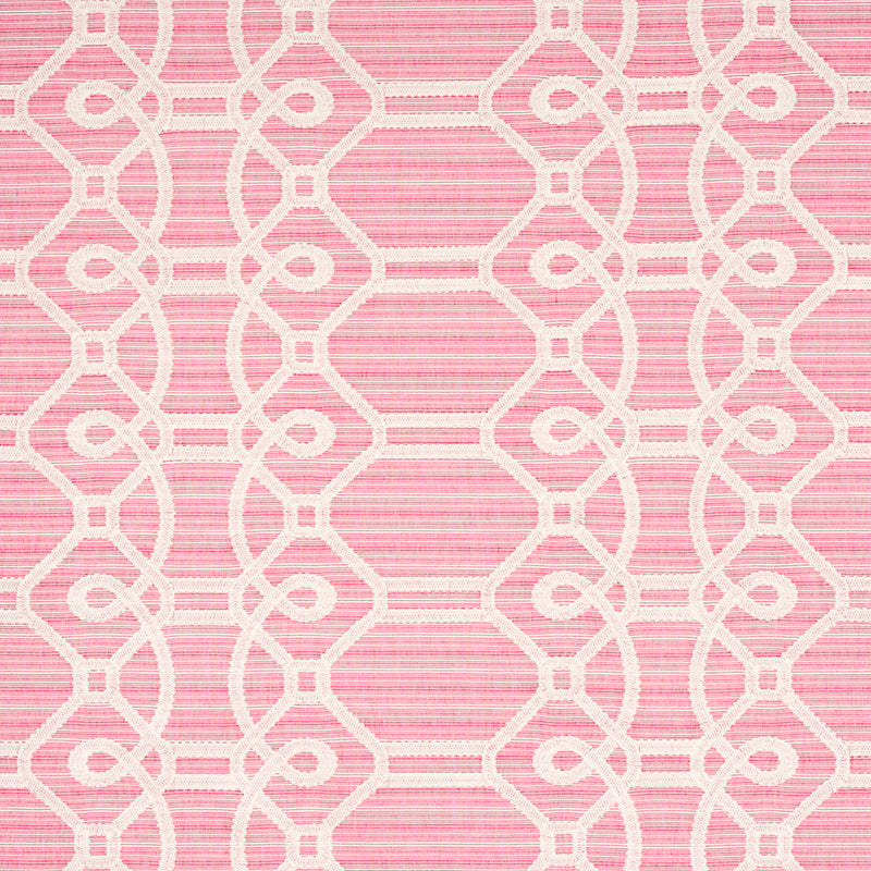 Pink fabric with white embroidery forming an interlocking lattice pattern; decorative textile for upholstery or drapery.