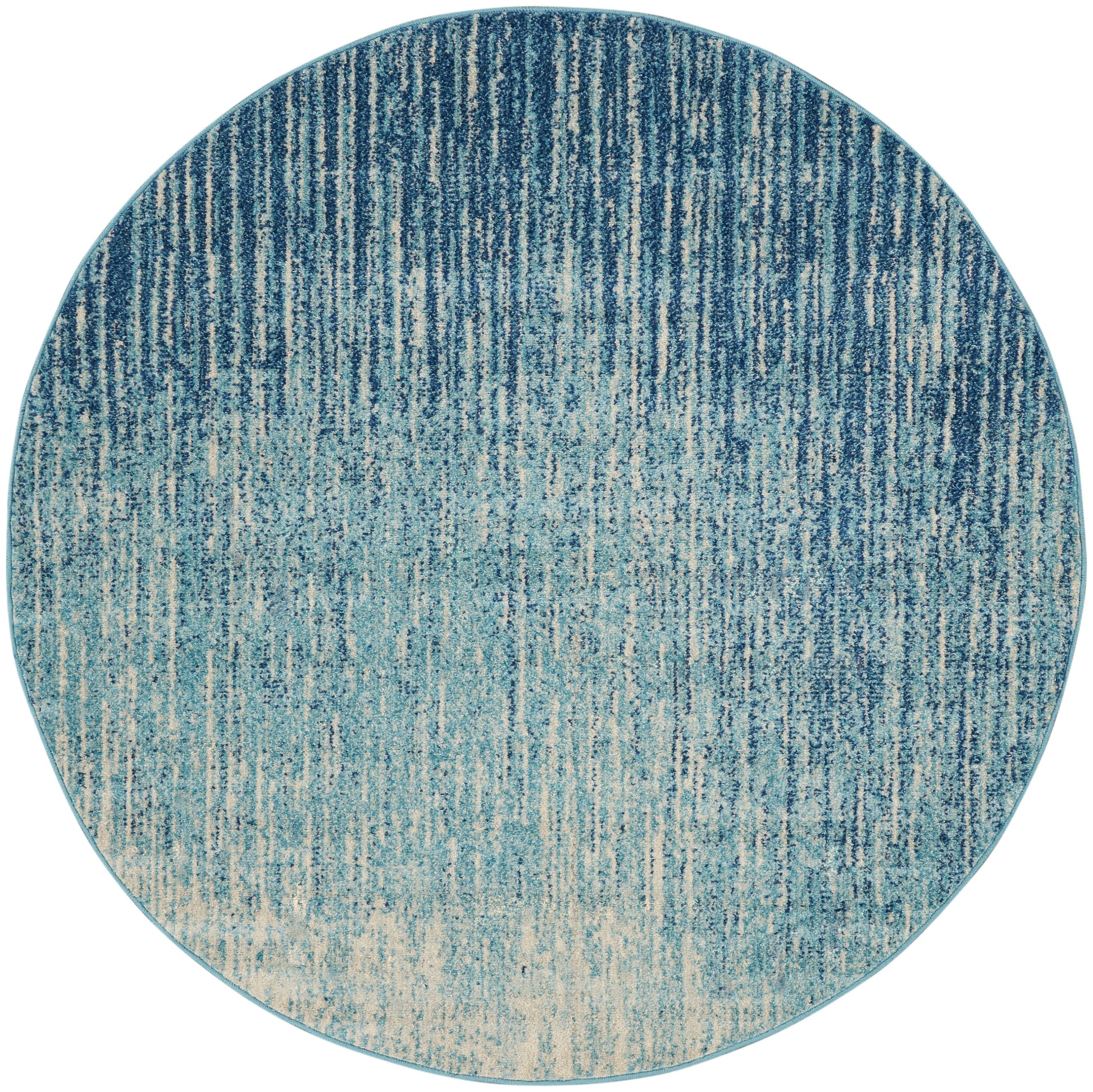 Round blue ombre rug with vertical brushed texture, deep navy to pale teal, soft woven look.