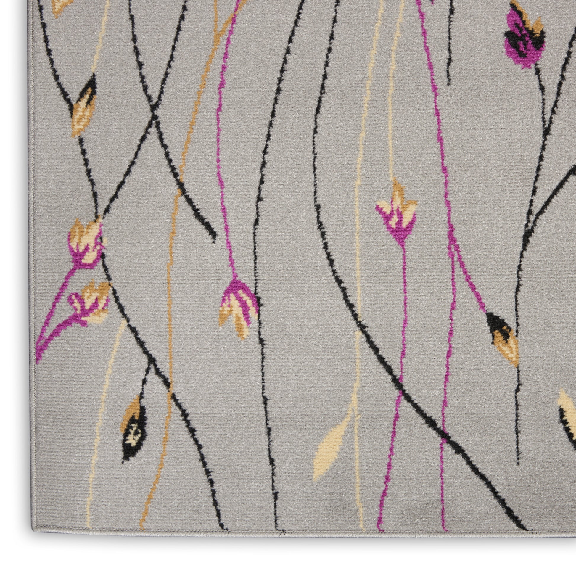 Light gray area rug with black vine-like lines and pink and yellow floral accents in a modern botanical pattern.