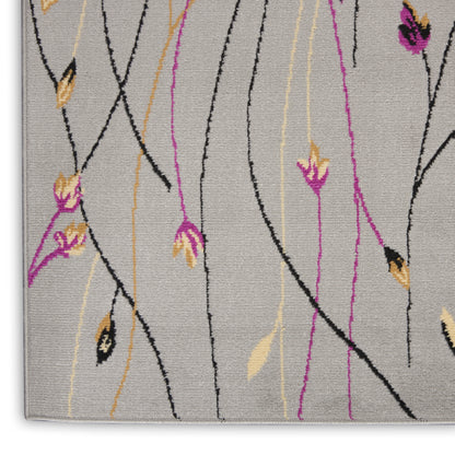 Light gray area rug with black vine-like lines and pink and yellow floral accents in a modern botanical pattern.