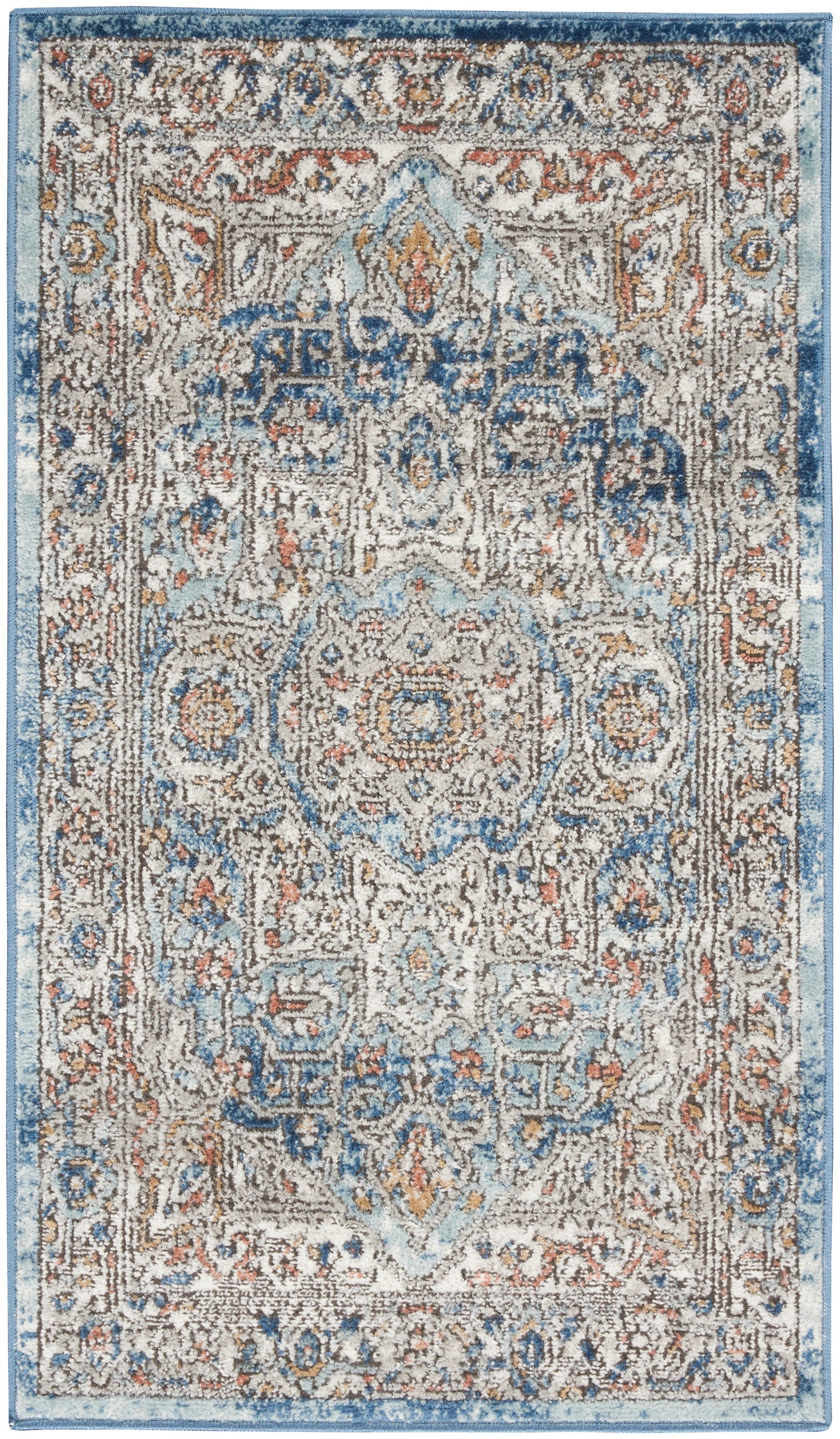 Rectangular oriental rug with distressed blue and cream tones, central medallion, floral motifs, and rust accents.