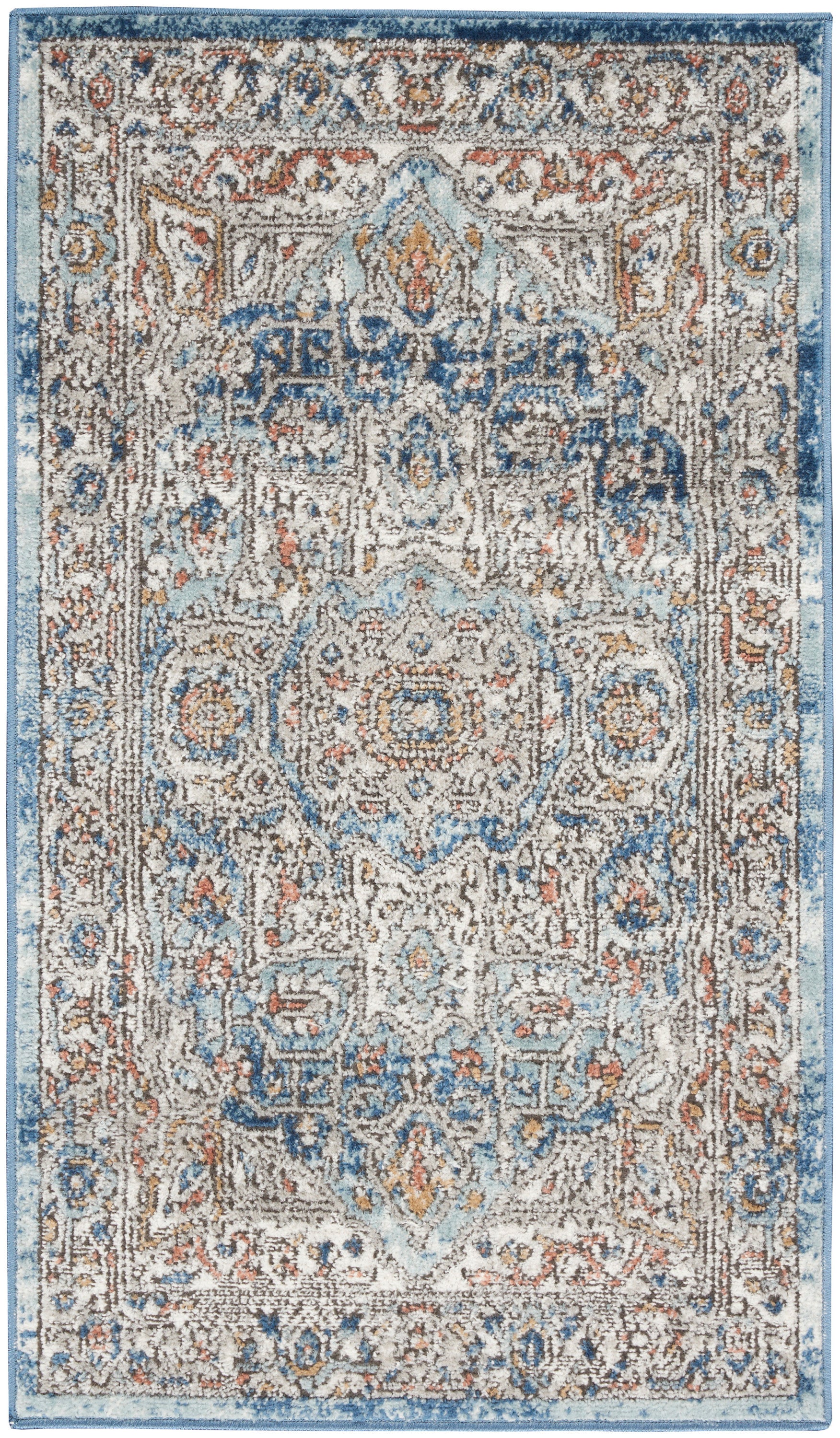 Rectangular oriental rug with distressed blue and cream tones, central medallion, floral motifs, and rust accents.