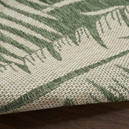 Beige woven rug with sage green palm leaf pattern; textured fabric with edge fold.