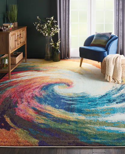 Soft plush rectangular area rug, 7' x 10', with vibrant swirling colors (pink, orange, teal, blue, purple) for a cozy living room.