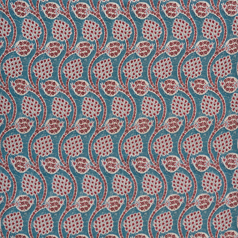 Turquoise fabric with red floral teardrop motifs and curved stems in a repeating paisley pattern.