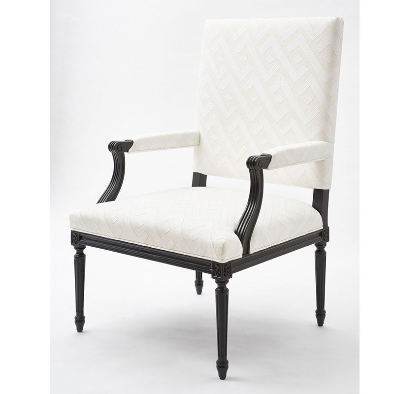 Blue applique-pattern woven fabric upholstery on a tall-back armchair with a black carved wood frame and turned legs.
