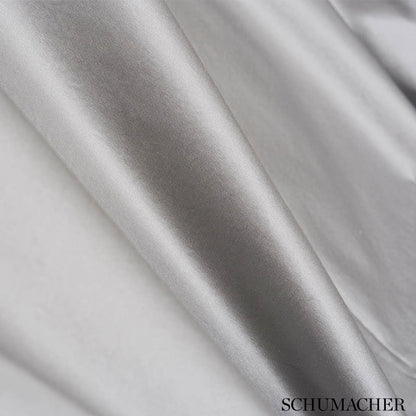 Shiny silver satin fabric draped in smooth folds.