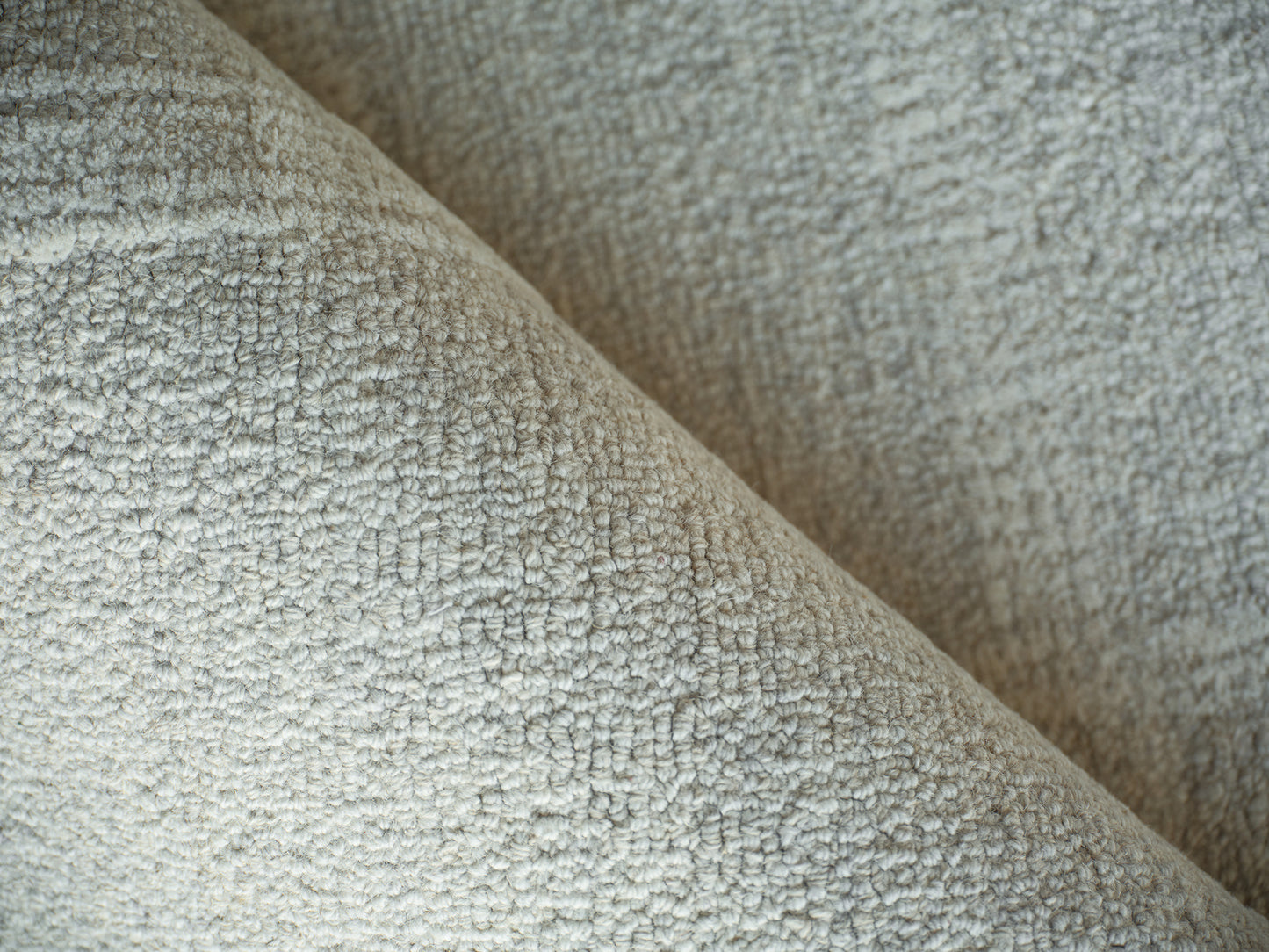 Close-up of a light beige boucle rug with a chunky, nubby texture; indoor hand-tufted, 4' x 6'.