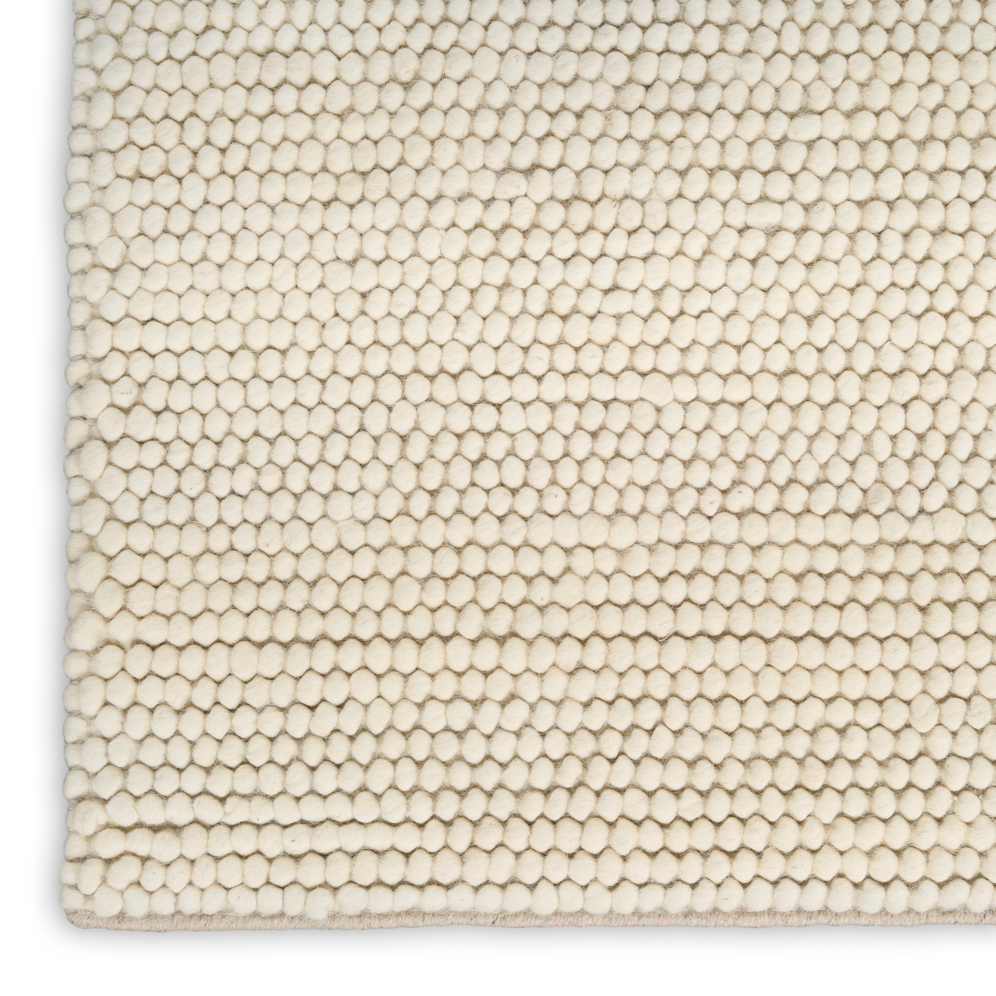Cream ivory looped rug close-up with tight honeycomb-like pile.