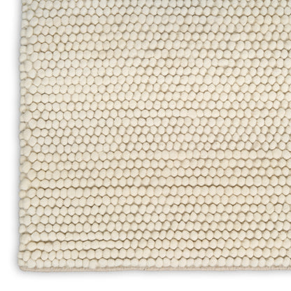 Cream ivory looped rug close-up with tight honeycomb-like pile.
