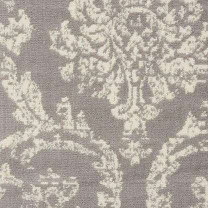 Gray damask textile with ivory floral motif; elegant jacquard upholstery or drapery fabric.