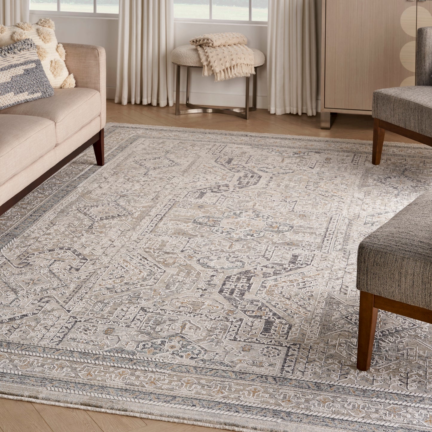 Woven gray and ivory oriental-style area rug with a medallion motif in a modern living room.