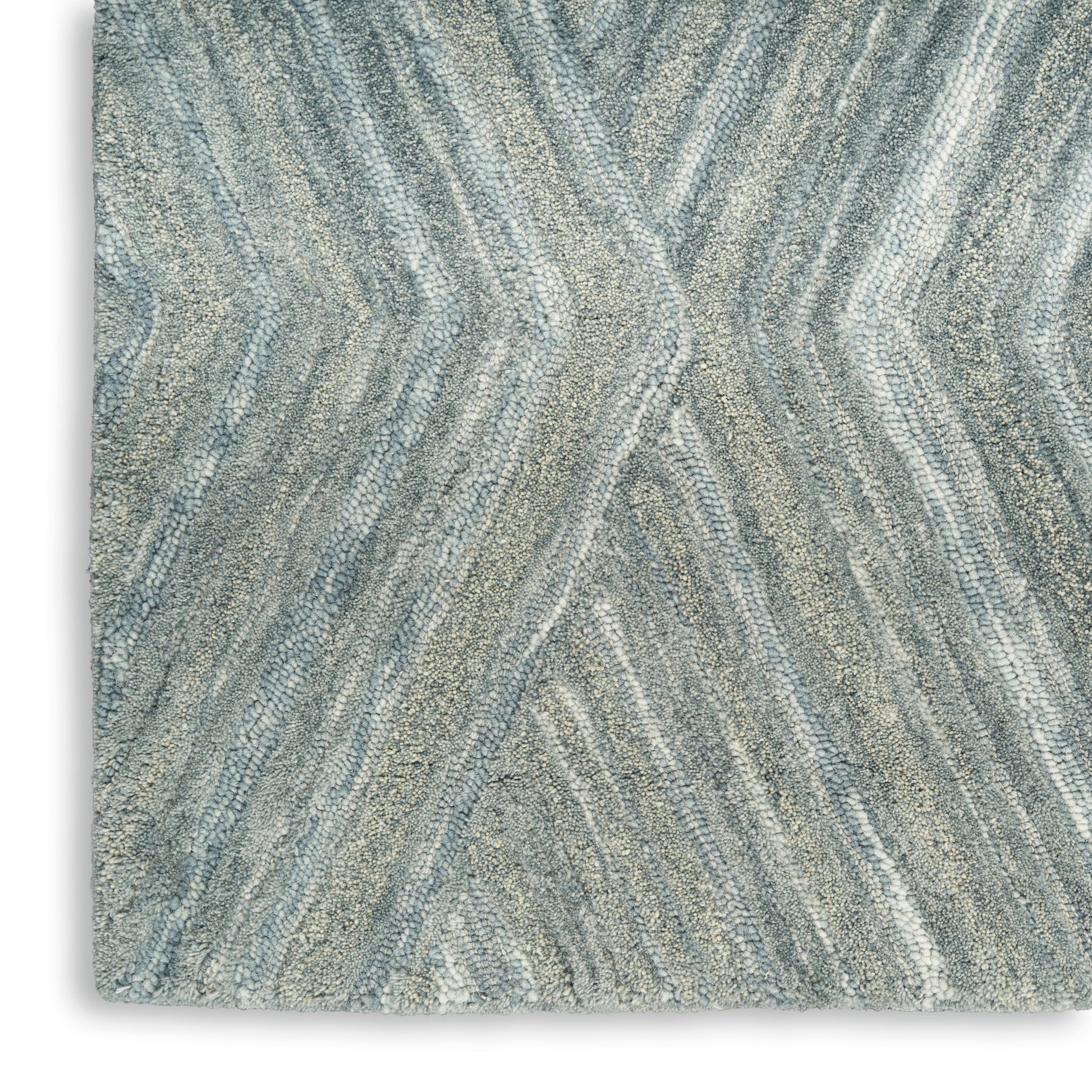 Grey-blue rug with soft, wavy chevron pattern and plush pile.