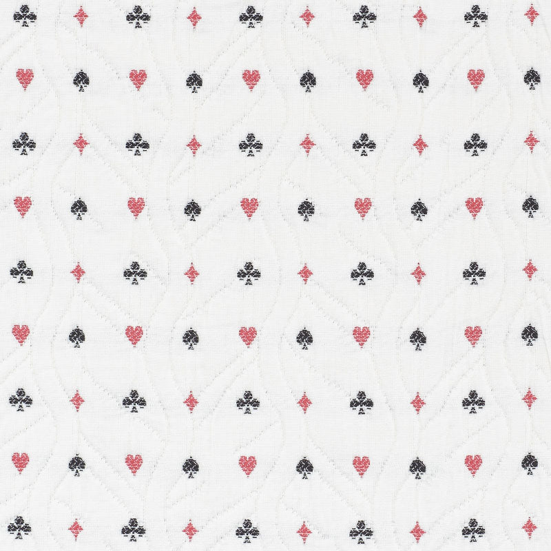 White quilted fabric with repeating red hearts and black clubs pattern and subtle stitched wavy lines.