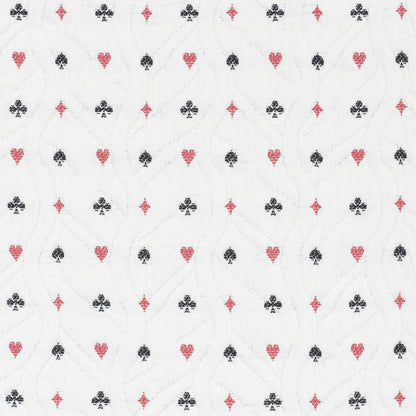 White quilted fabric with repeating red hearts and black clubs pattern and subtle stitched wavy lines.