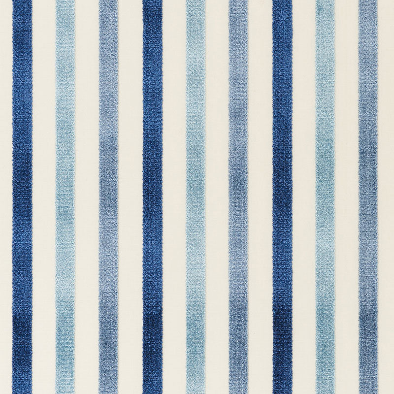 Blue striped rug with dark navy and light blue vertical stripes on a cream background.