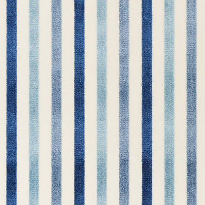 Blue striped rug with dark navy and light blue vertical stripes on a cream background.
