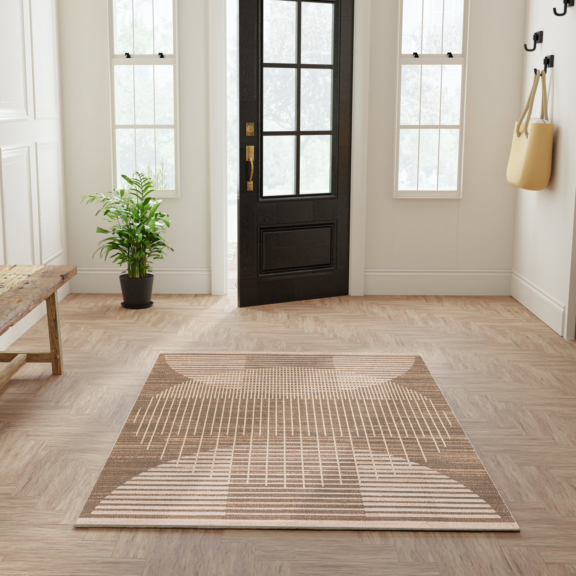 Rectangular flatwoven beige geometric rug with arcs and stripes for a modern entryway.